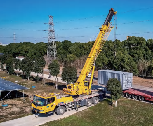 Truck-mounted crane lifting solar container